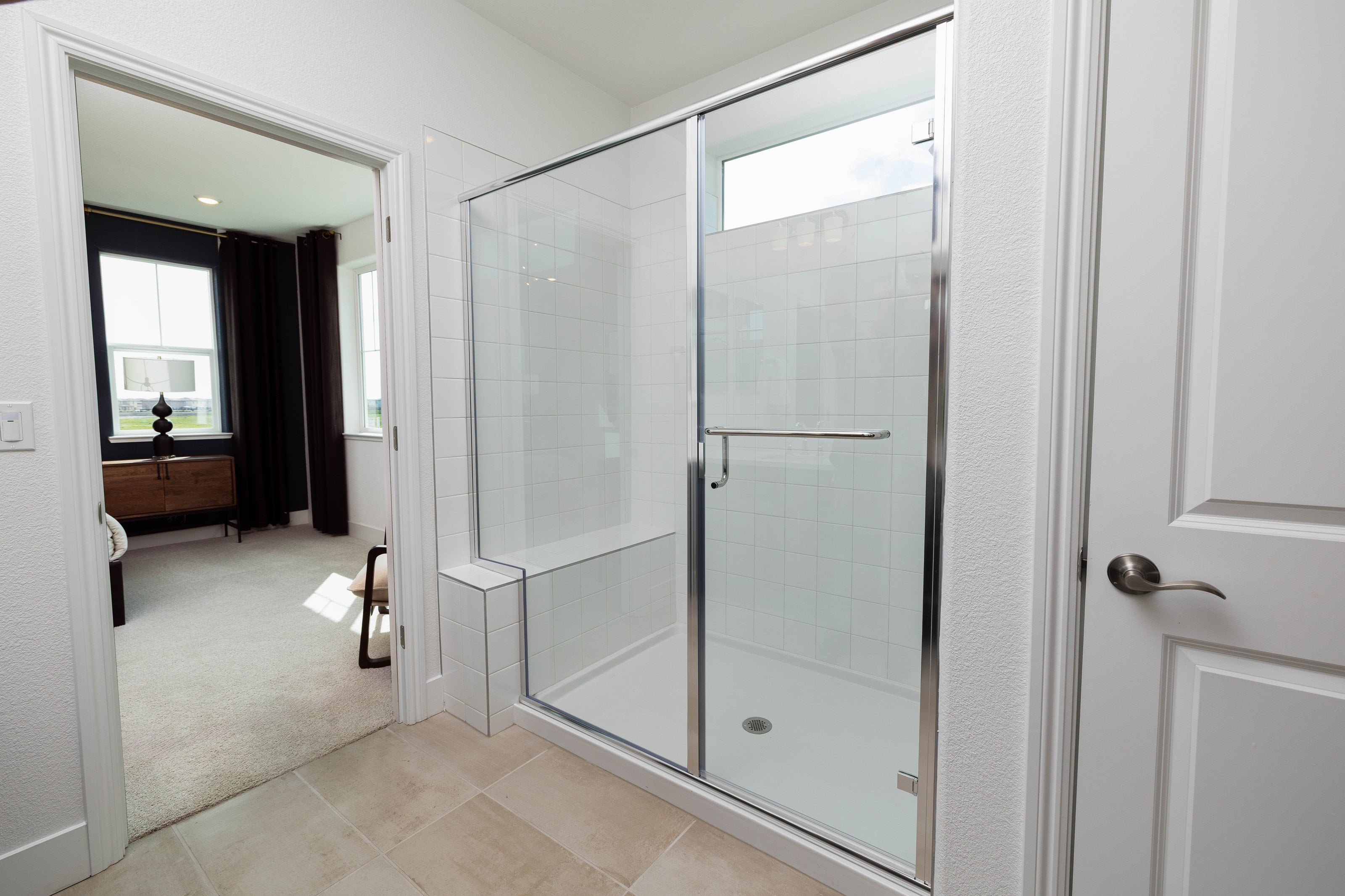 Silver-framed glass shower door installation